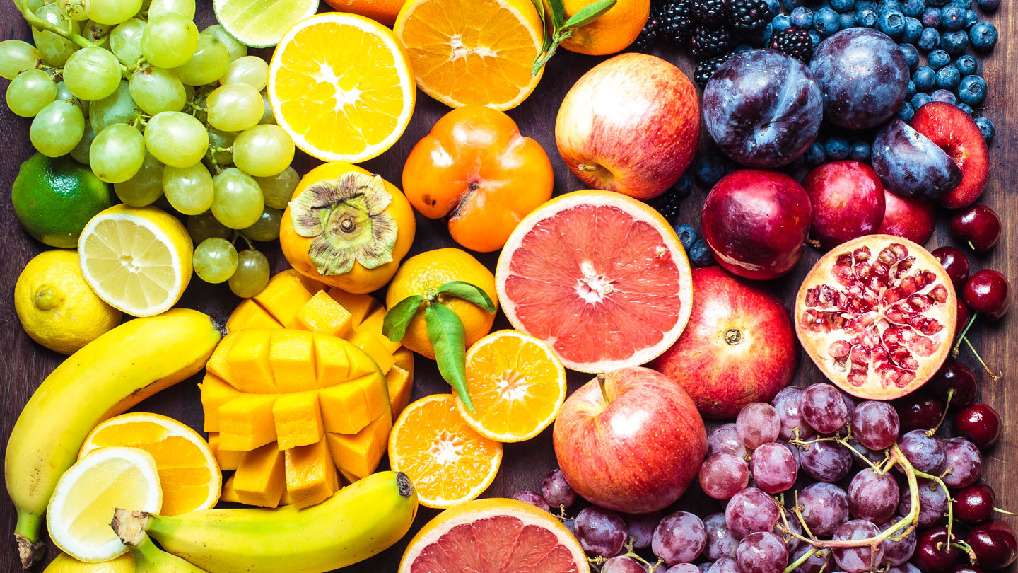 Vibrant and colorful assortment of fruit on a wooden table